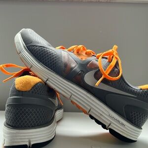Grey Nikes with orange laces